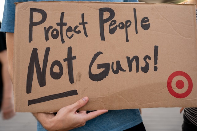 protest sign reading protect people not guns - gun control