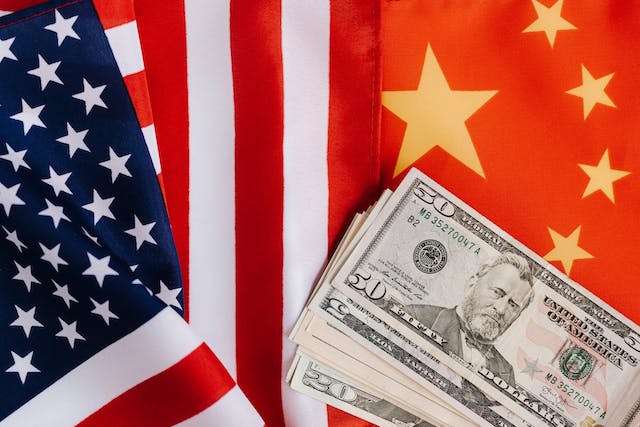 us & china flags with american currency