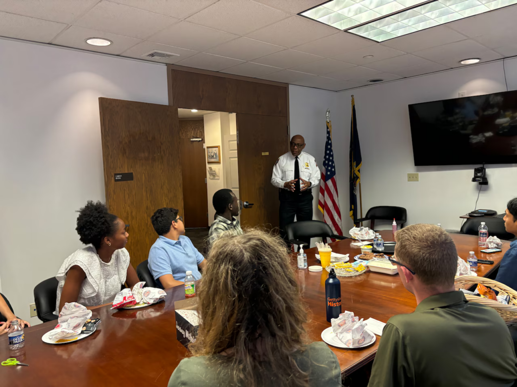 Public Safety Commissioner Thomas C. Carter greets students sharing lunch with Mayor Wanda Williams in her chambers.