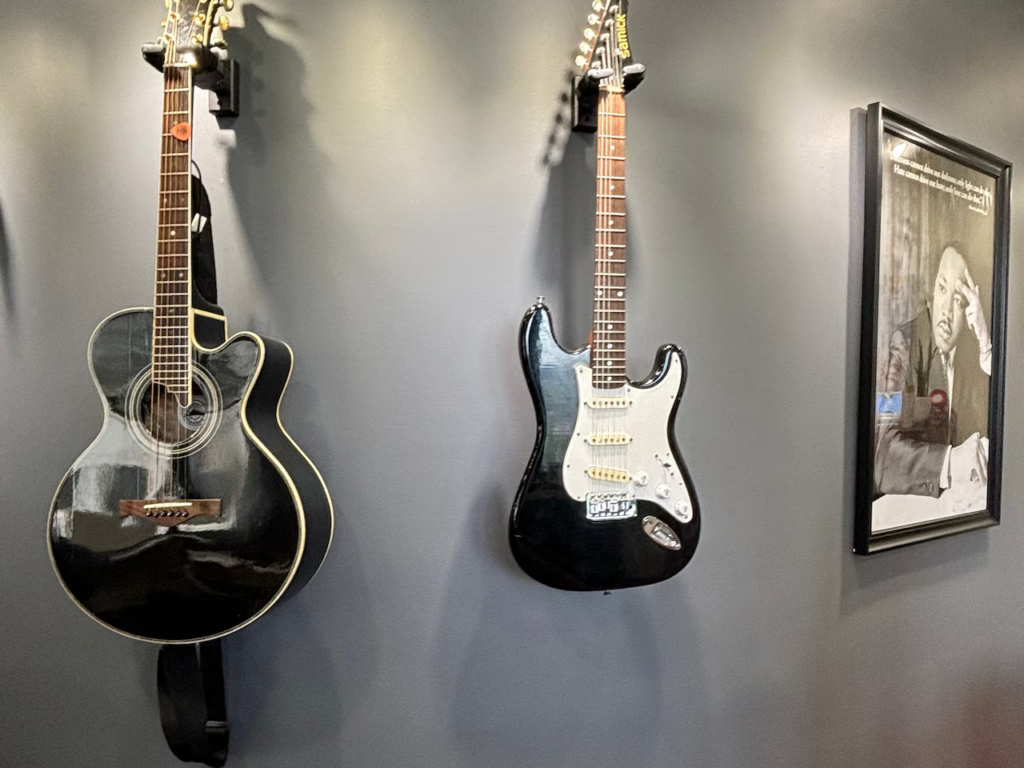 Two electric guitars hang from the wall in the office of new Dauphin County Commissioner Justin Douglas.