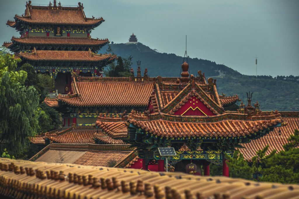 Explore the stunning ancient architecture of a Chinese pagoda in Shanxi, featuring intricate roofs and lush surroundings.