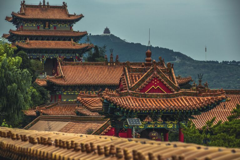 Explore the stunning ancient architecture of a Chinese pagoda in Shanxi, featuring intricate roofs and lush surroundings.